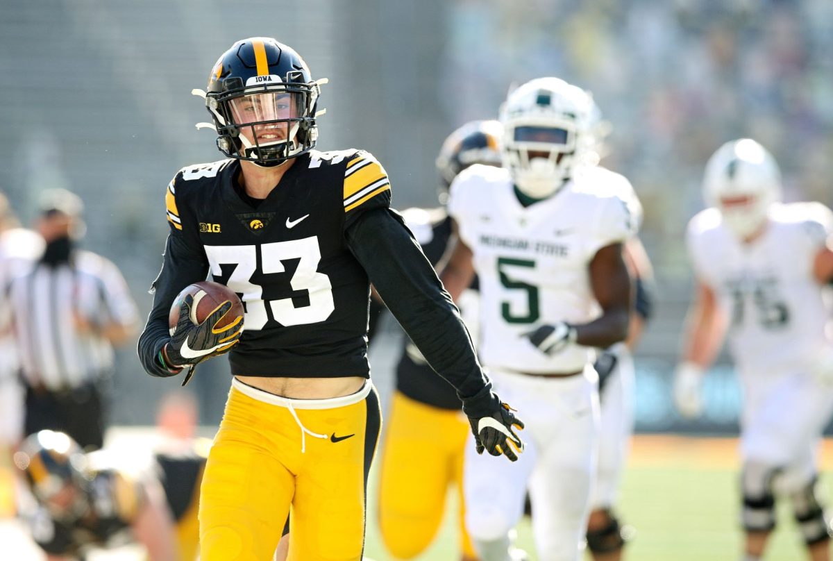 Iowa defensive back Riley Moss (33) intercepts a pass and returns it for a touchdown during the second quarter of a game against Michigan State at Kinnick Stadium in Iowa City on Saturday, Nov. 7, 2020. (Stephen Mally/hawkeyesports.com)