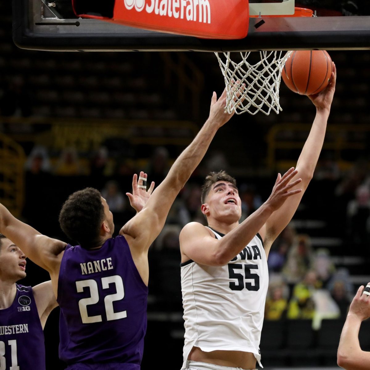 Iowa center Luka Garza (55) goes to the hoop against Northwestern Wildcats forward Pete Nance (22) Tuesday, Dec. 29, 2020, at Carver-Hawkeye Arena in Iowa City. (Stephen Mally/hawkeyesports.com)