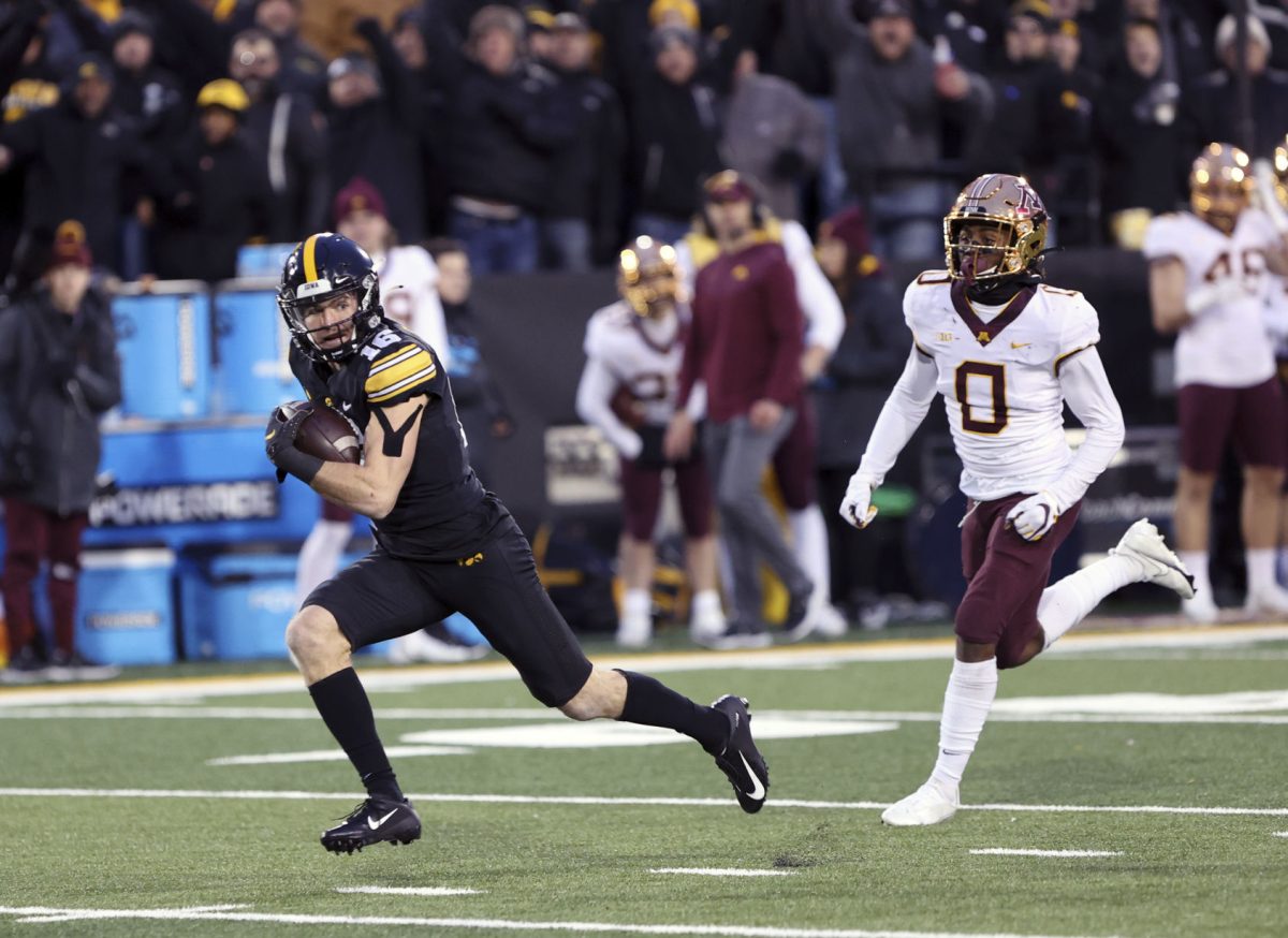 Charlie Jones picks up some yards for the Hawkeyes during their win over Minnesota.