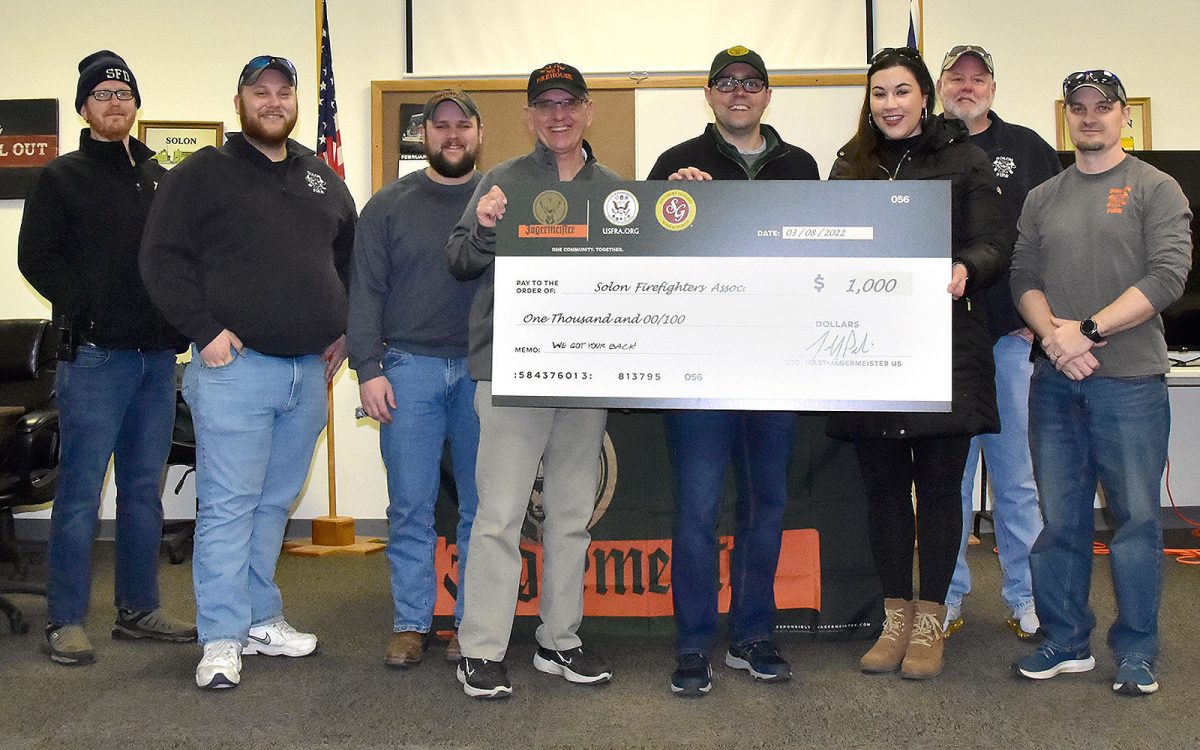 Solon Firefighter Greg Morris accepts a $1,000 check to the Solon Firefighter&#8217;s Association from Ryan Camuso, Area Manager for Mast-J&#228;germeister US, and Breann O&#8217;Hern, Eastern Iowa Sales Manager for Southern Glazers Wine and Spirits. The check for the new fire station was presented Tuesday, March 8, with firefighters Brian Huyck, Dean Stange, Jamie Linden, Jon Reyhons and Doyle Spence present.