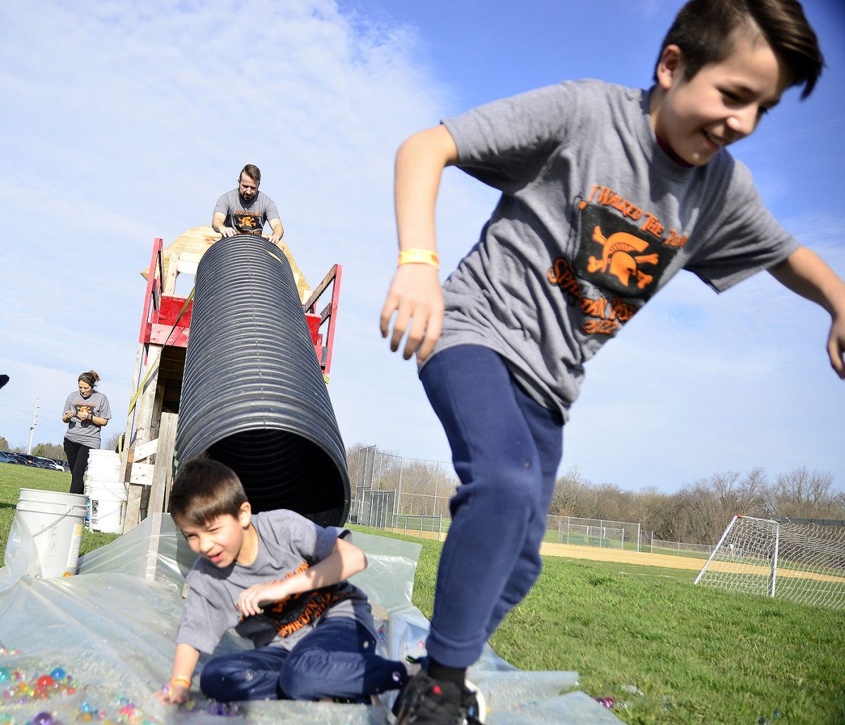 Participants in the 2022 Spartan Dash started the nine-event, one-mile course with &#8220;Big Mouth,&#8221; a challenging climb followed by sliding down a tube into a pile of slippery ORBEEZ.