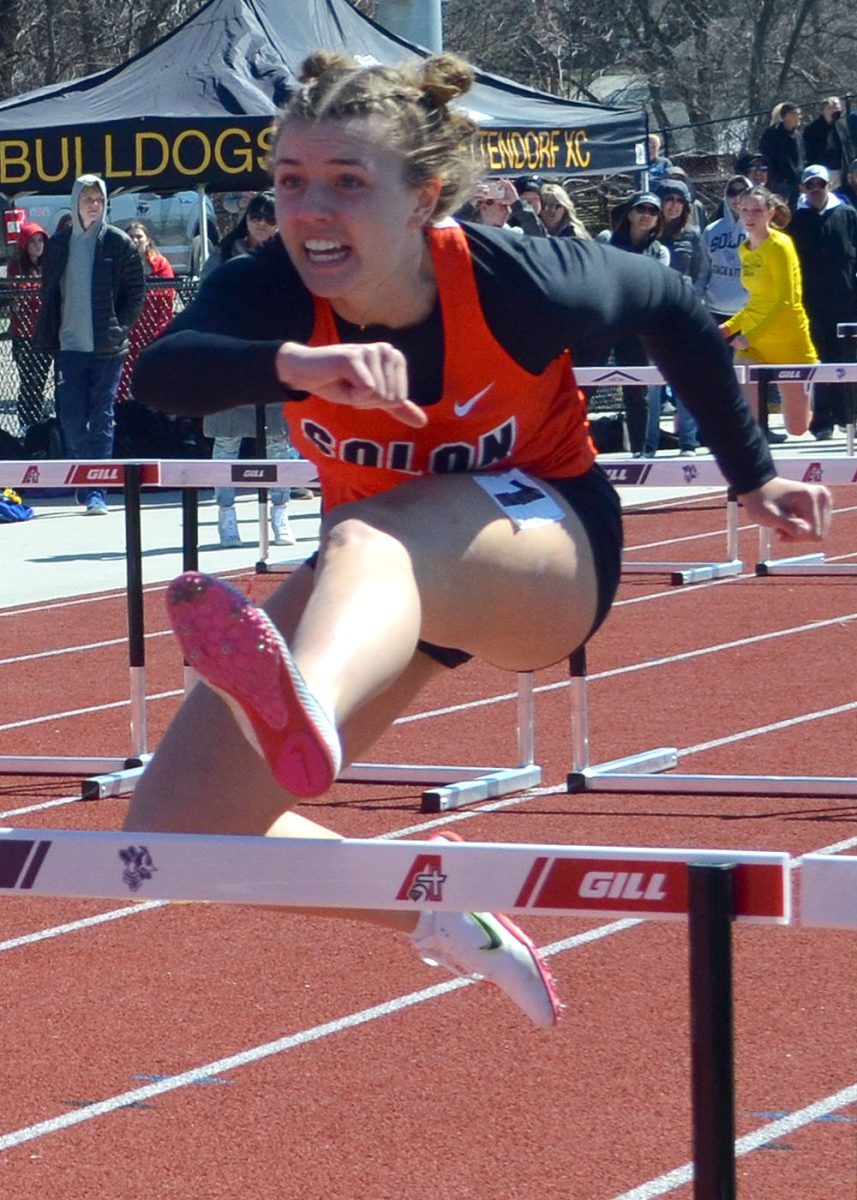 Mia Stahle gets her lead leg down, in the shuttle hurdle relay, April 9 in Davenport at the Assumption Coed Invitational. Solon finished second here, just beating the qualifying standard to run later this month at the Drake Relays