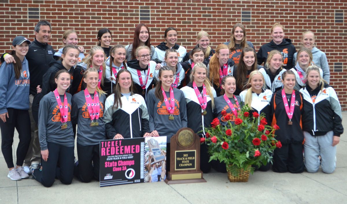 End of the meet, and Championship plaque in hand, Solon&#8217;s girls track team celebrates it&#8217;s &#8216;just won&#8217; Class 3A track title at Drake Stadium in Des Moines, May 21. Solon put up 84 points to hold off Adel-DeSoto-Minburn (ADM) with 66, as well as 50+ other 3A schools there for the championship.