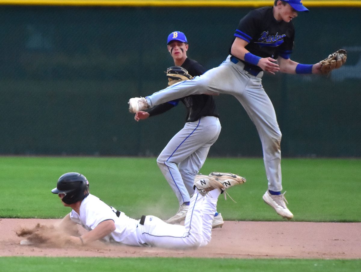 Brett White slides safely into second base as Benton Community&#8217;s Jordan Thys lands with the ball Tuesday, May 31 in Solon. The Spartans split with the Bobcats winning 8-2 and falling 7-5.