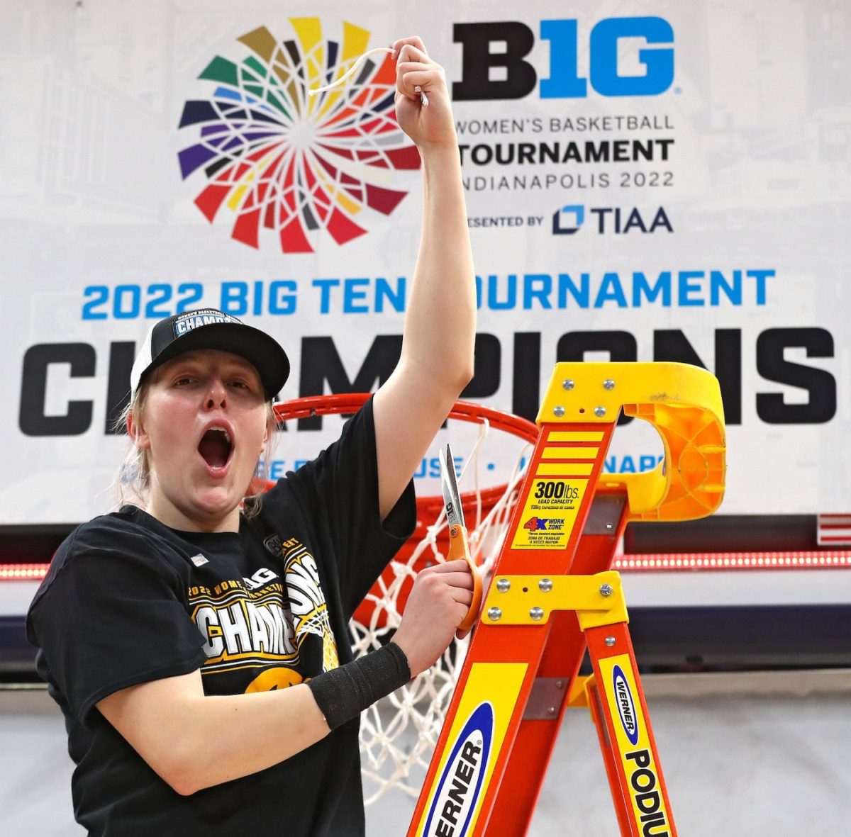 Monika Czinano cuts down the net at the 2022 Big Ten Championship game.