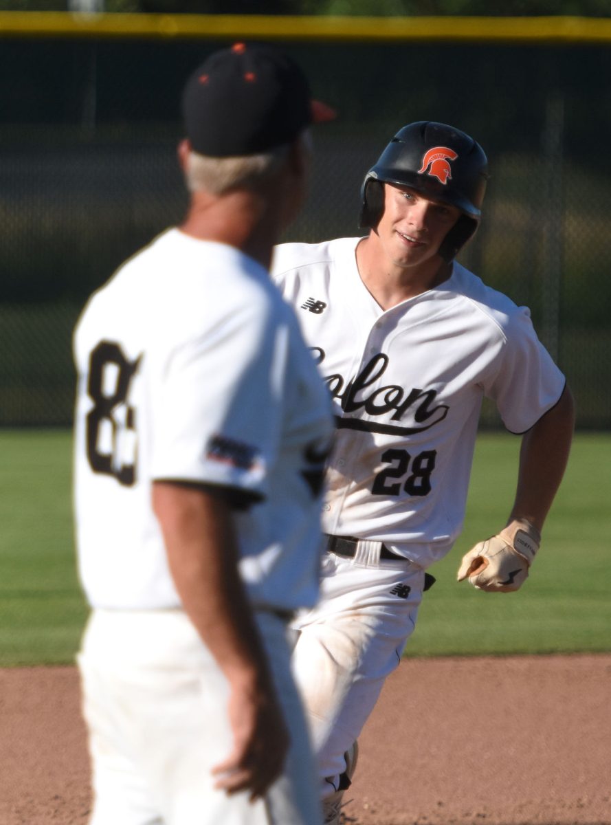 Brett White celebrates a two-RBI homer in game one of a doubleheader Thursday, June 23 at home against Mount Vernon. The Spartans swept their rivals 13-4 and 10-7. White also nailed an RBI triple.