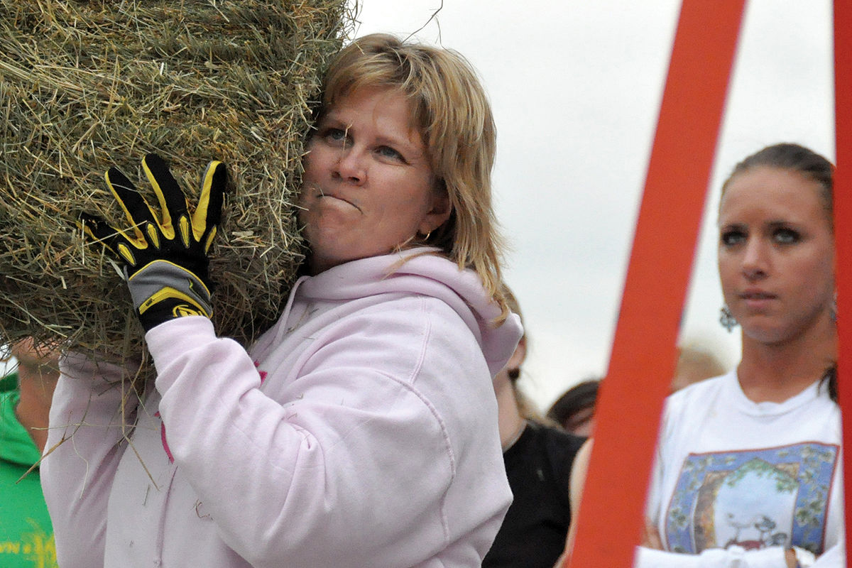 <p>Nikki Weis gets ready to heave the bale as Gwen Morelock watches in anticipation during the 2009 Solon Beef Days Hay Bale Toss. Weis wound up the Women’s Champion with Morelock the runner up.</p>