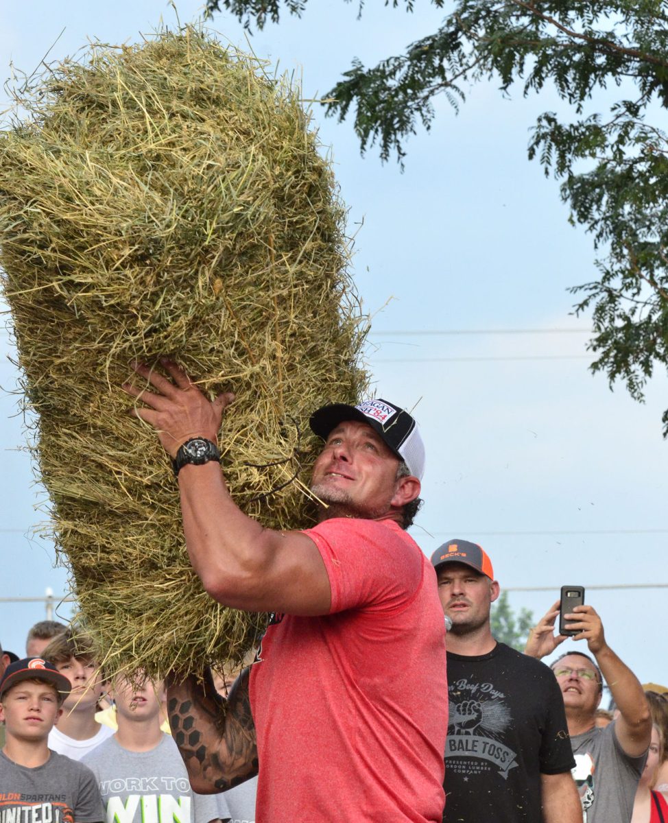 Justin Brosh gets ready to heave a bale up over a bar during the 2022 Solon Beef Days Hay Bale Toss held Friday, July 15.