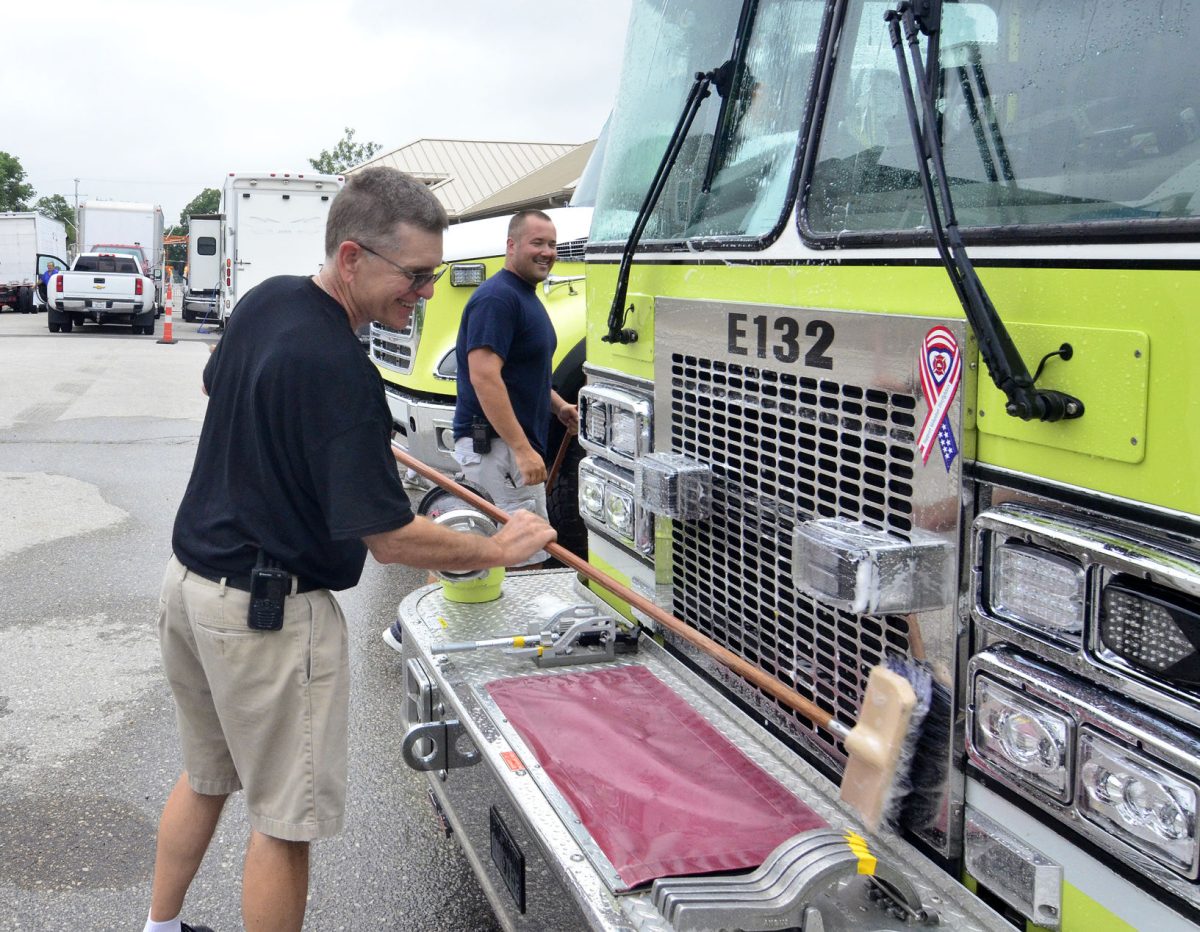 Solon firefighter Greg Morris washes the front of Engine 132 Saturday, July 16 in preparation for the annual Beef Days Parade.