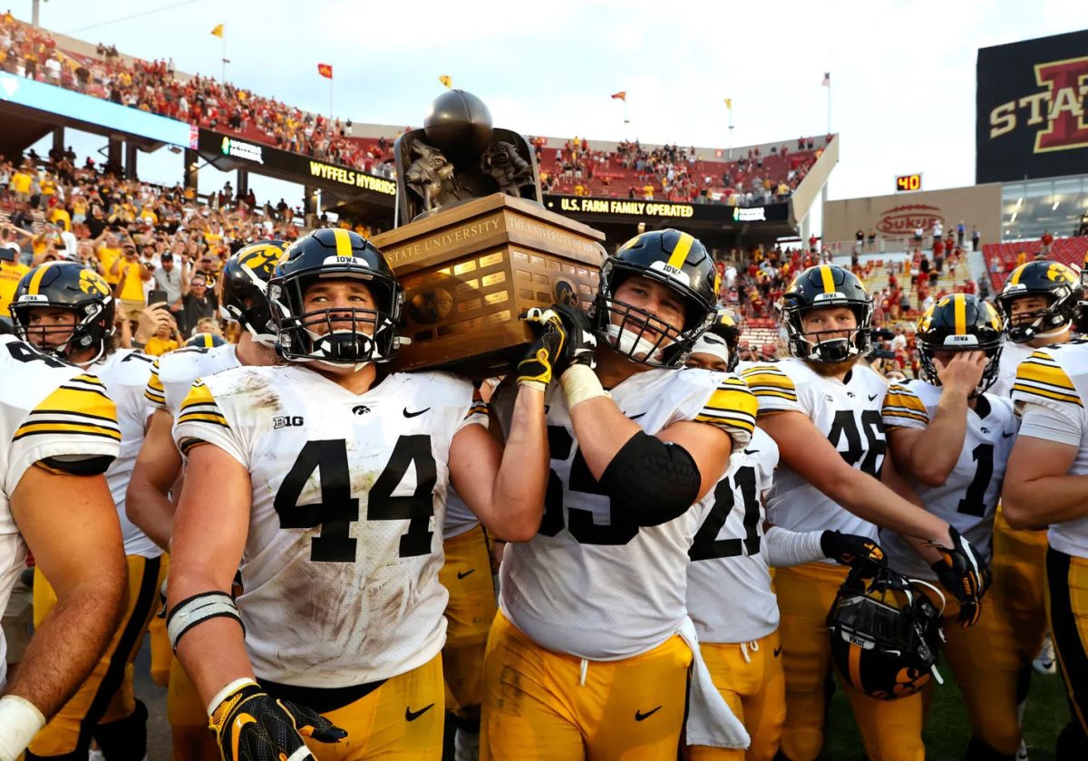 Iowa Hawkeyes linebacker Seth Benson (44) and offensive lineman Tyler Linderbaum (65) celebrate with the Cy-Hawk trophy following their win against the Iowa State Cyclones Saturday, Sept. 11, 2021, at Jack Trice Stadium. The Hawks and Cyclones will clash on Sept. 10 this year.