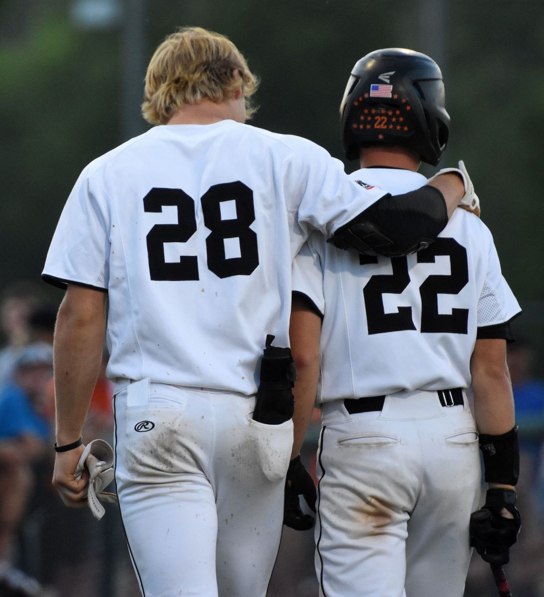 Brett White (28) consoles Colin Werner after Werner struck out for the final out of a Class 3A substate quarterfinal game against Maquoketa Saturday, July 9 at home. The Cardinals defeated the Spartans 7-5. White was named to both IABaseball.com and the Iowa High School Baseball Coaches Association Class 4A All-State 1st Teams.