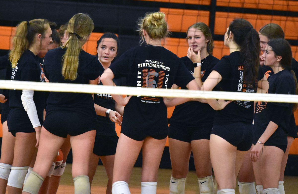 <p>Coach Mikayla Long meets with her players between matches during an evening of scrimmages with West Branch Sunday, August 7. Long, a Solon alum, is in her first year as the head coach after previously serving as an assistant.</p>