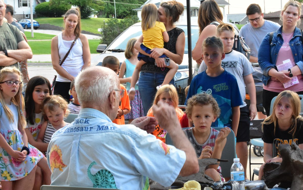 Jack Neuzil tells how he made wooden dinosaurs and traveled to area schools during a Thursday, August 11 &#8220;Dinosaurs at Dusk&#8221; event at the Solon Public Library.