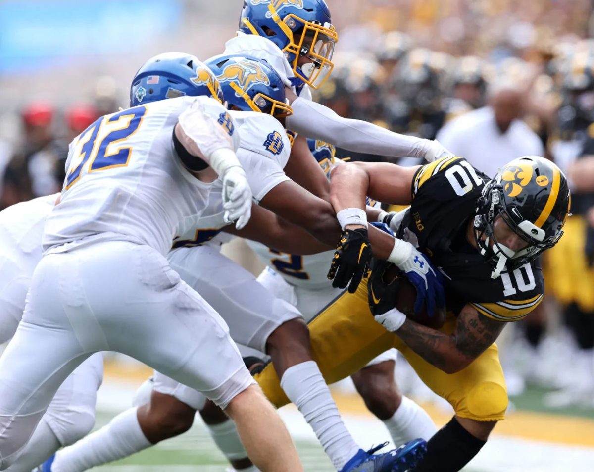 <p>Solon HS grad Adam Bock (32) and his fellow Jackrabbits gang up on Iowa’s Arland Bruce IV Saturday, Sept. 3 at Kinnick Stadium. Bock led the Jackrabbits’ defense as Iowa defeated South Dakota State 7-3 in the season opener, and was named Missouri Valley Football Conference Co-Defensive Player for Week One. Bock made six solo and seven assisted tackles.</p>