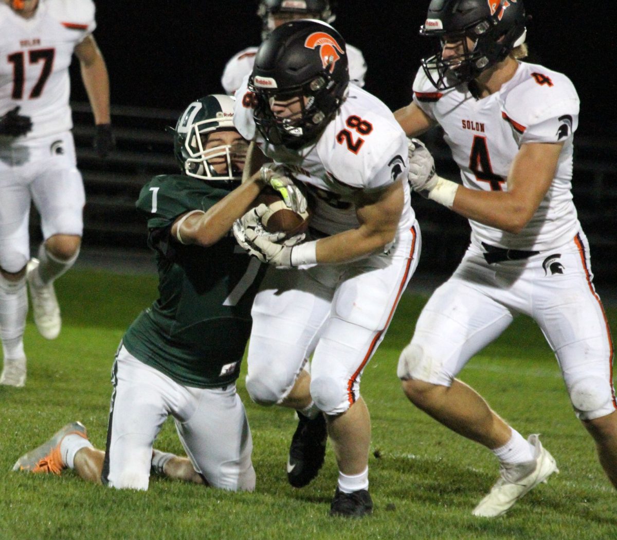 Brett White (28) carries the ball as Mac McCarty (4) prepares to block Friday, Sept. 23 at West Burlington.