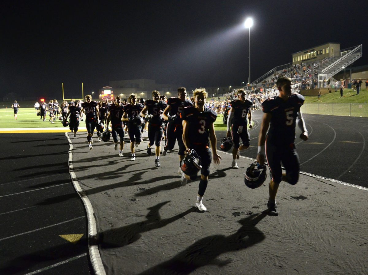 Victorious Spartans run off the field Friday, Sept. 16 after snapping a two-game losing streak with a 35-10 win over Assumption Catholic (Davenport) at home.