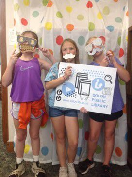 Friends enjoy our Library Card photo booth and celebrate getting new library cards this month.