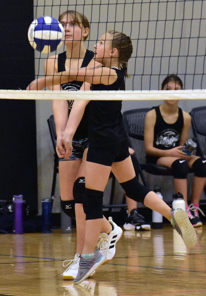 Abigail Rose beats Kenzie McKelvy to a dig Sunday, October 16 at the Solon Middle School during the 5th and 6th grade girls youth volleyball tournament.