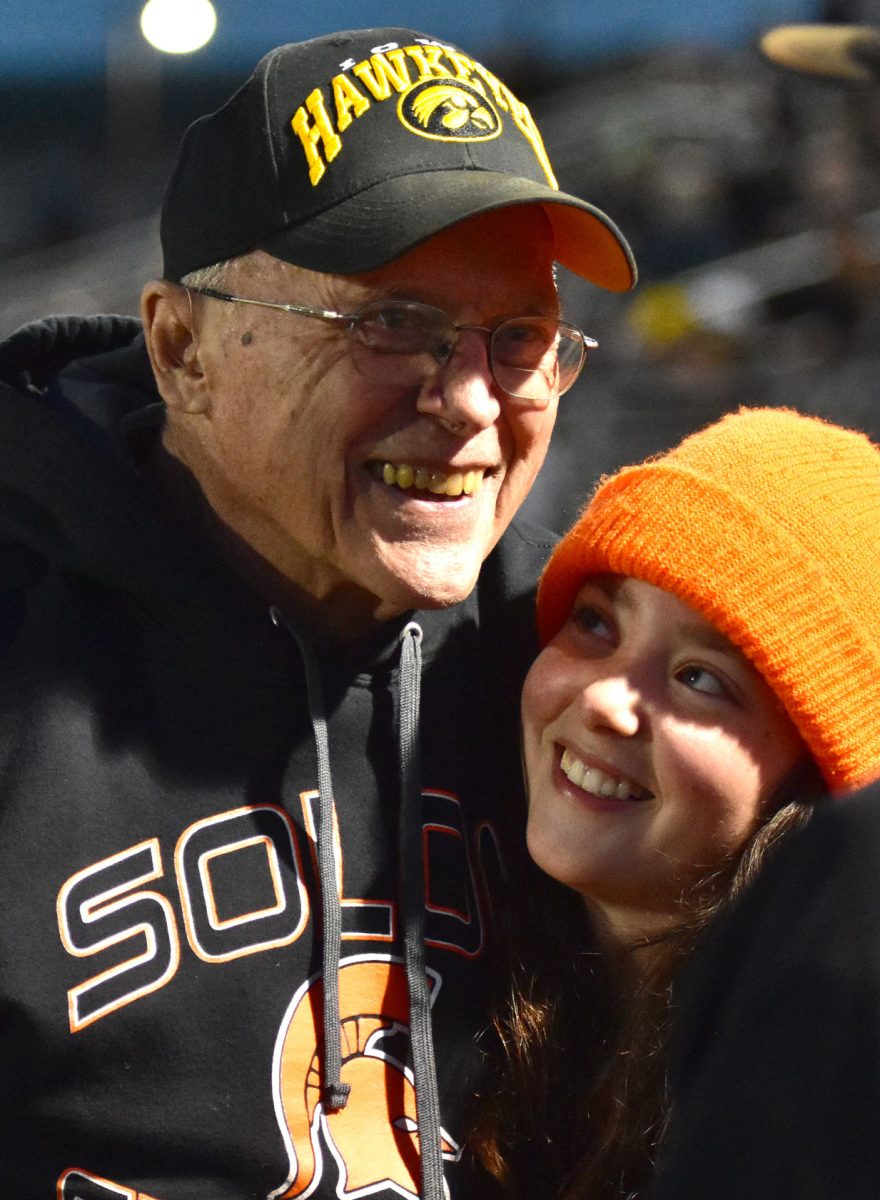 <p>Grace Fiala looks lovingly at her grandpa Terry before the 2022 Homecoming game Friday, Sept. 30. Terry Fiala was named Honorary Captain for the game.</p>