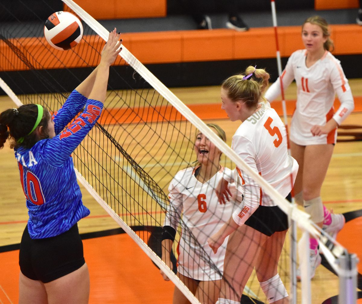 <p>Kylee Flynn (6) and Izzy Frees (11) react as Yasmine Sell (5) makes a kill in the second set against Albia Wednesday, October 19 in a 3A Regional semifinal. The Lady Spartans went on to sweep the Blue Demons 3-0 to advance to the Regional final with a trip to the State Tournament on the line.</p>