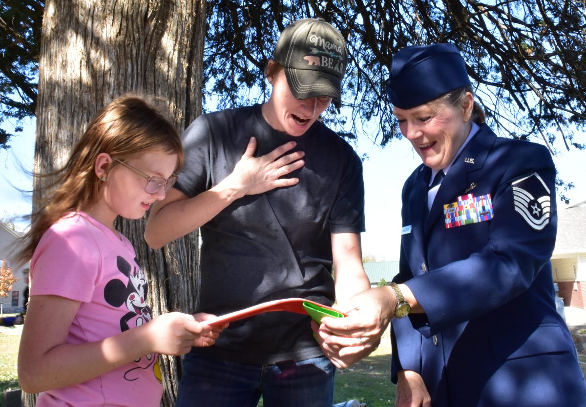 Tiffany Halverson and LeAnn Hugeback (at right) look through Tiffany&#8217;s genealogy research after a brief ceremony honoring Joseph Kahout, a Civil War veteran buried in St. Mary Catholic Cemetery in Solon. Joseph&#8217;s sister is Tiffany&#8217;s 3rd great grandmother.