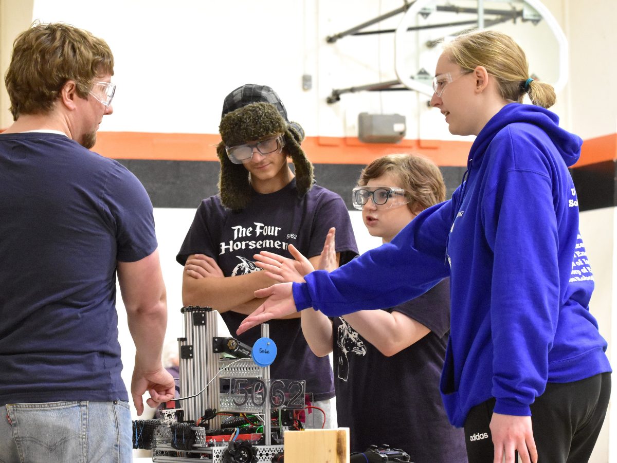 Toby Kleinsmith, Haeley Ball, and Abby Kramer (team Four Horsemen) go through inspection Thursday, Nov. 17 before competing in a robotics tournament at the Solon Community Center. Not pictured &#8211; Sophia Miles.