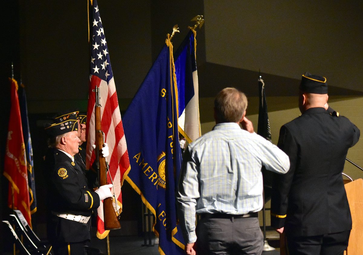 <p>Air Force and Iowa Air National Guard veteran Dan Dall and American Legion Stinocher Post 460 Commander Adam Hopp salute during the playing of Taps during the annual Veterans Appreciation program Friday, Nov. 11 at the Solon High School.</p>