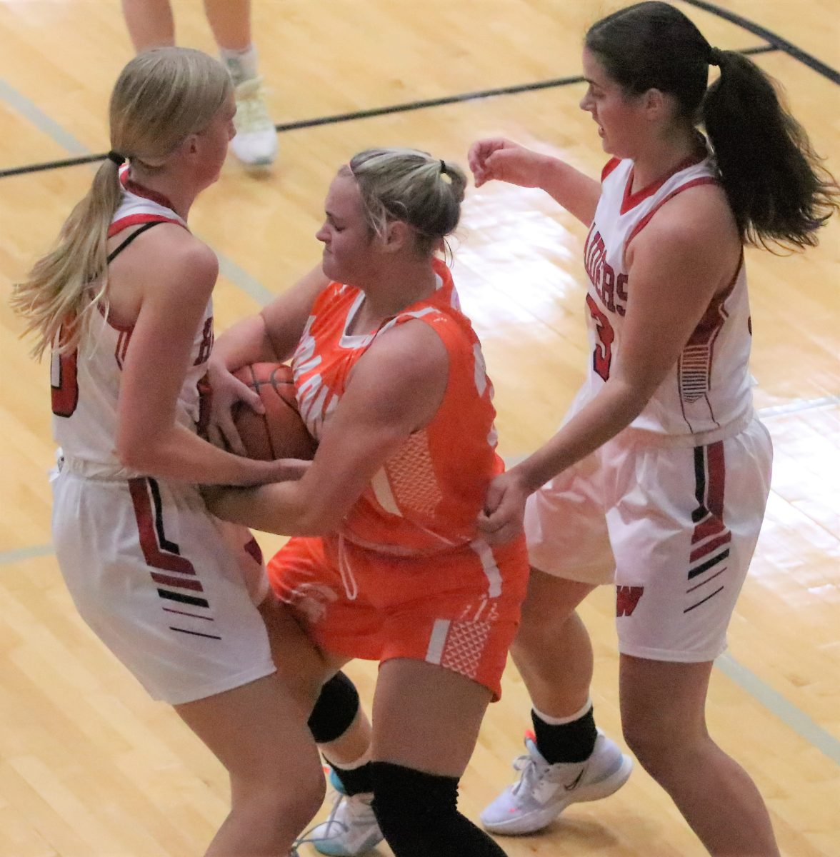 Hilary Wilson wrestles the ball away from a Raider Friday, Dec. 2 in Williamsburg.