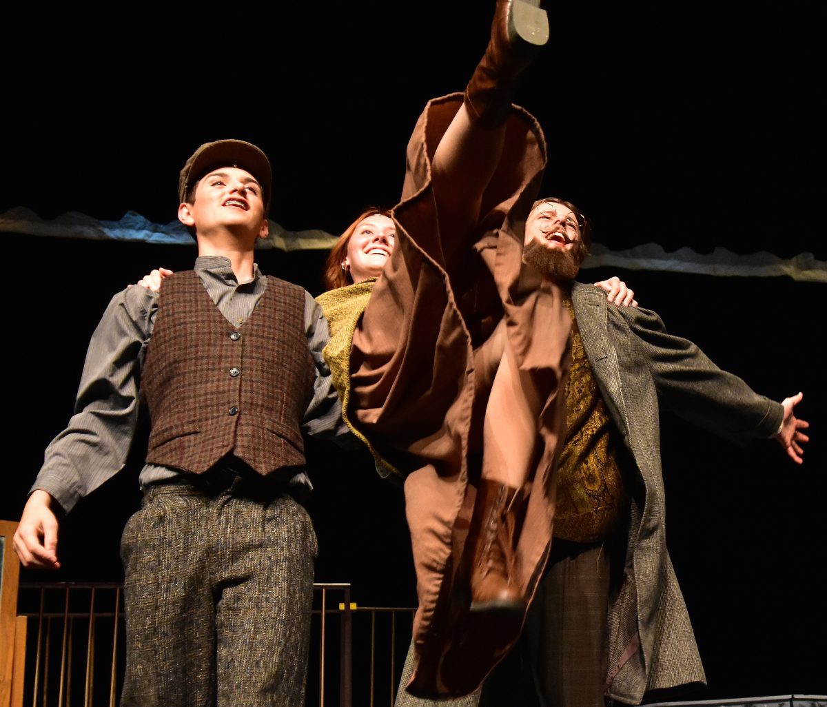 Vlad (Jakob Bovenmyer) and Dmitry (Brady Evers) lift up Anya (Kerrigan Lyons) during a dress rehearsal for Anastasia.