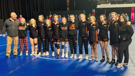 The Solon Lady Spartans wrestling team poses before the start of their Super Regional meet Friday, Jan. 27 at the Alliant Energy PowerHouse arena in Cedar Rapids.