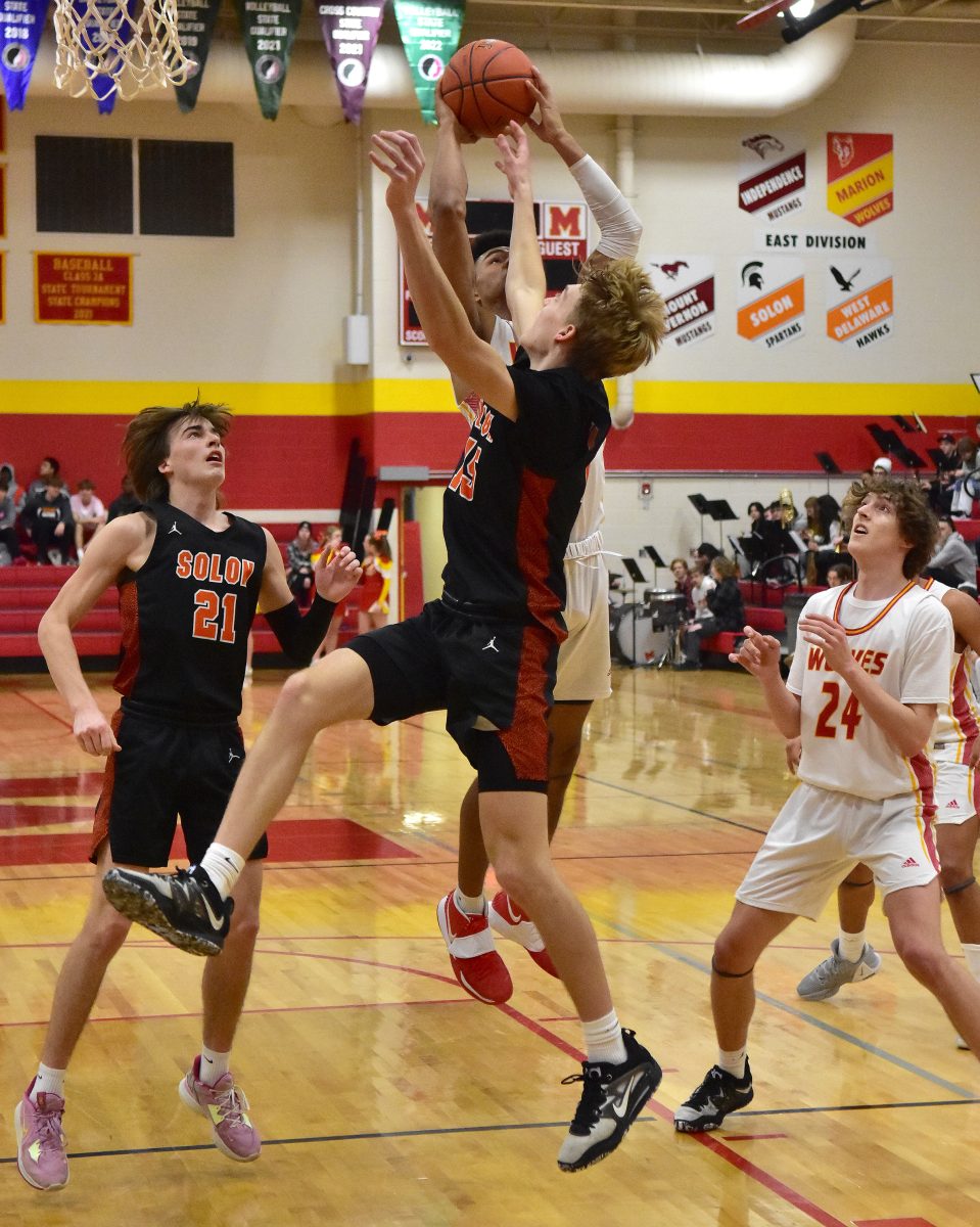 <p>Jake Benzing battles a Marion player for a rebound Tuesday, Jan. 24 at Marion High School.</p>