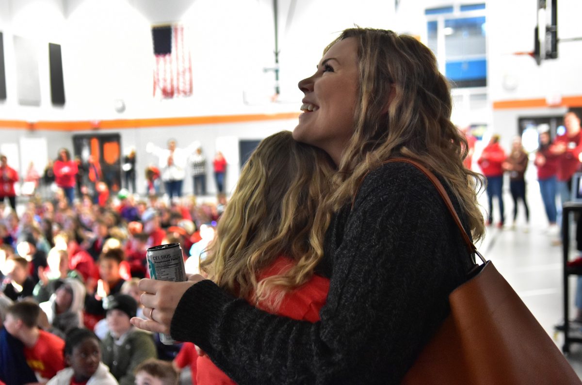 Grace Ehlinger hugs her mother Jessie as she is overcome with emotion as her father Sgt. 1st Class Travis Ehlinger was a surprise Zoom guest during a special Wear RED (Remember Everyone Deployed) Friday event Feb. 10 at the Solon Intermediate School.