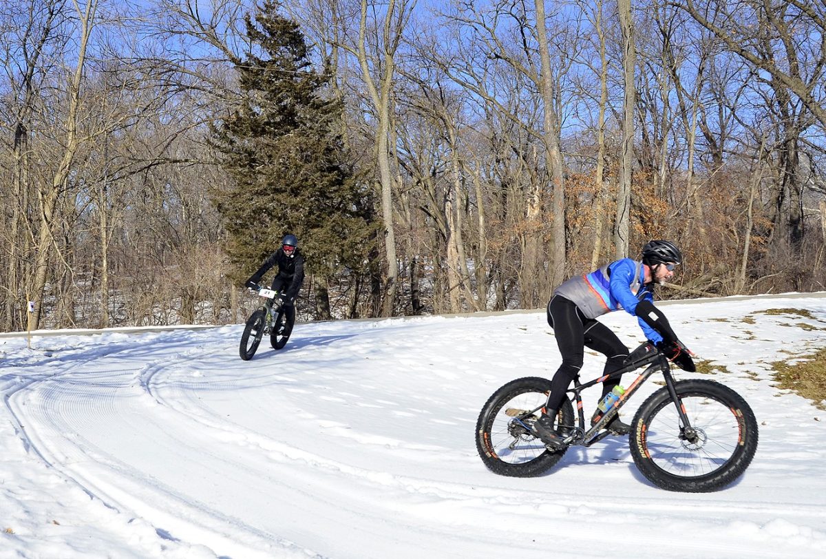 <p>A pair of riders negotiate a sharp U-turn while participating in the fifth annual Fat Tire Classic race Feb. 12, 2022, at Lake MacBride State Park. The sixth annual event is scheduled for this Saturday morning.</p>