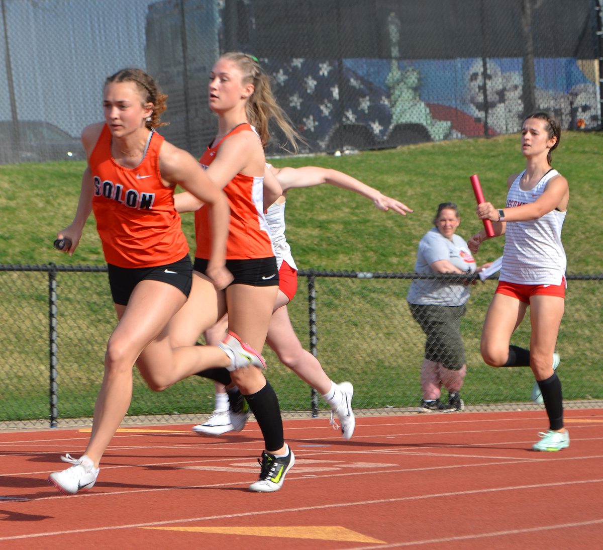 <p>Emma Wolff delivers the baton to Mia Stahle for her 200 meter leg on the sprint medley relay during the April 14 Linn-Mar Invitational track meet. Solon’s girls were second in the 15-team meet, which was won by Linn-Mar.</p>