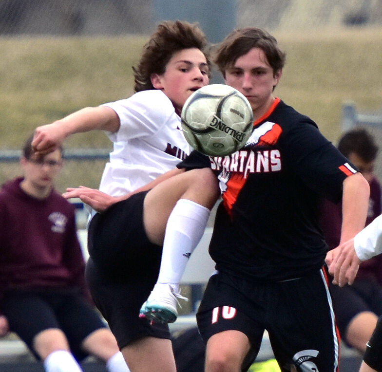 Tucker Spence (10) battles an Independence Mustang Thursday, March 30 in Solon. Spence scored one goal in a 4-3 loss for the Spartans.