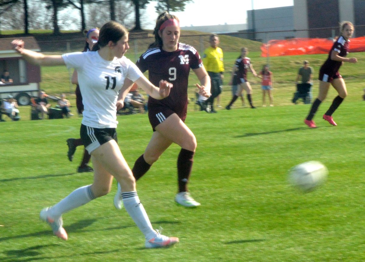 Elena Swan (11) launches the ball ahead of Mount Vernon&#8217;s Adeline Whisner Tuesday, April 11 in Mount Vernon.