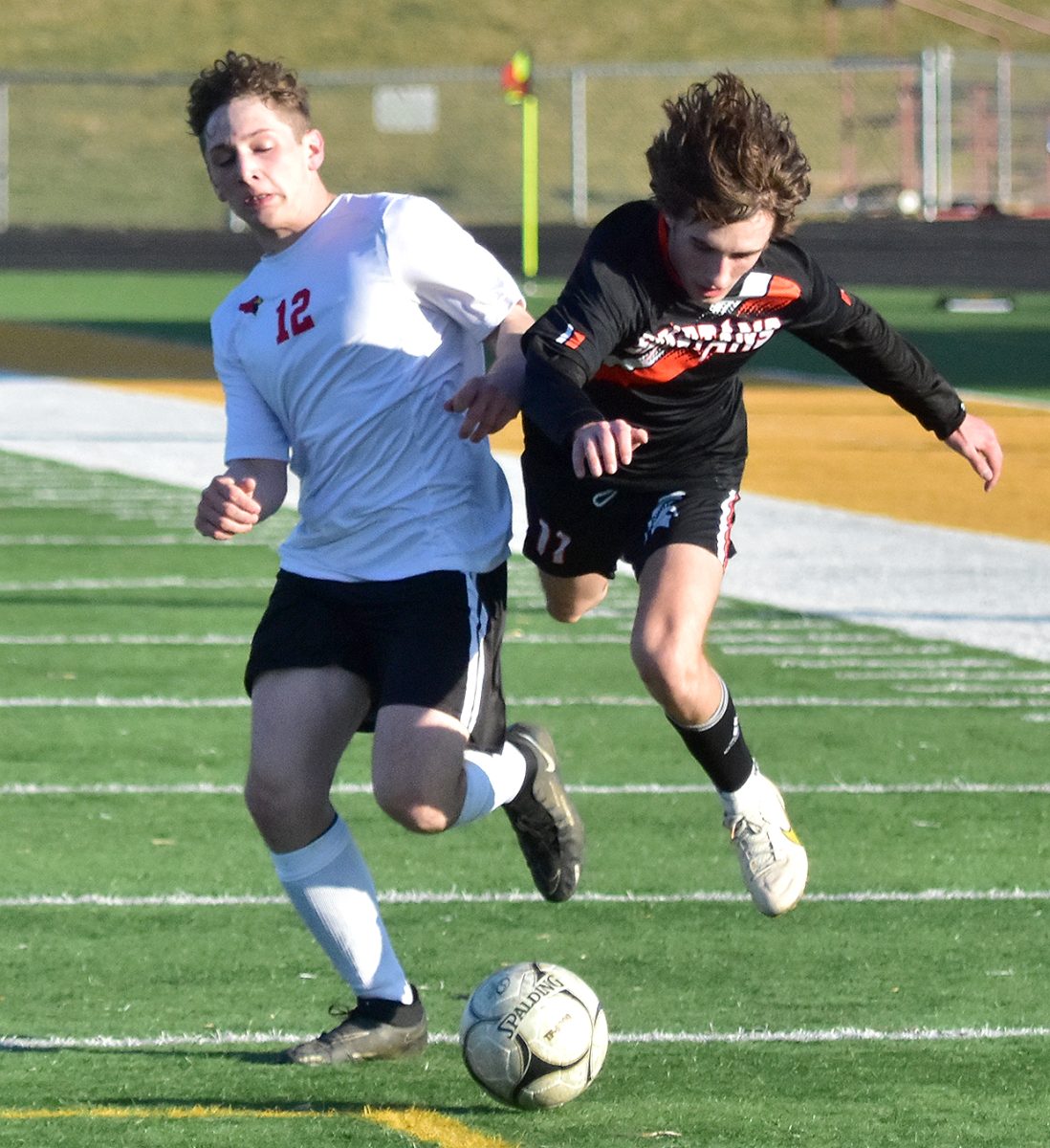 <p>Keegan Conway (11) draws a foul by Maquoketa’s Spencer Martin Thursday, April 6 in Solon. Conway was awarded a PK and scored on a put back after his initial kick bounced off the Cardinals’ keeper. Solon won the match 6-0.</p>