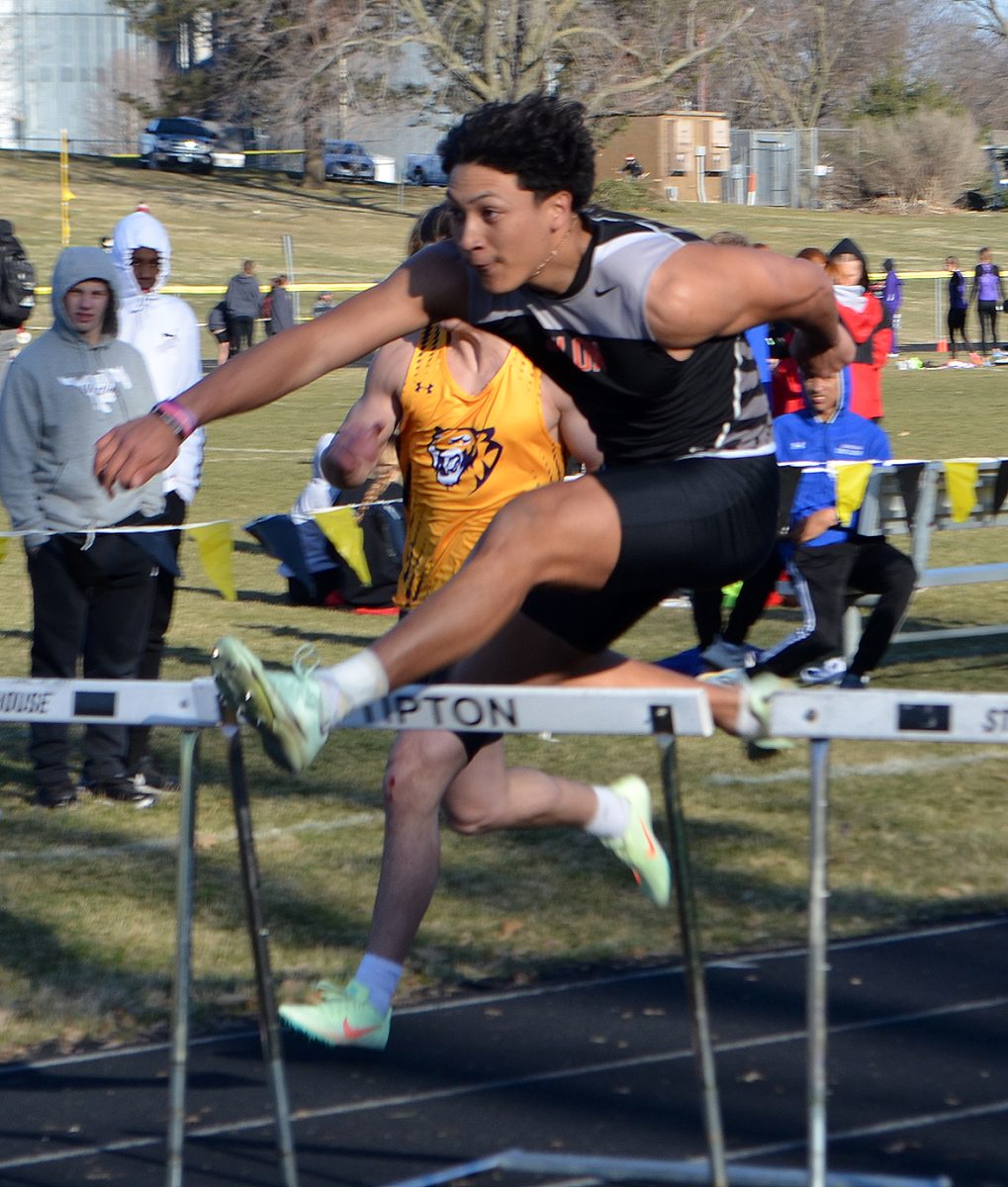 Nash Kotar leans into the hurdle during the shuttle hurdle relay March 28 at the Tipton Early Bird meet.