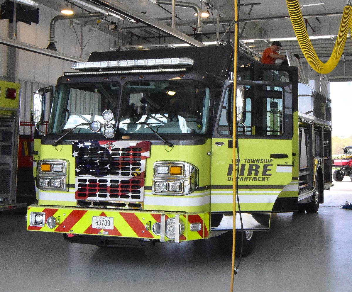 Solon firefighters place equipment in large &#8220;coffin compartments&#8221; on top of their new heavy rescue truck Saturday, April 15.