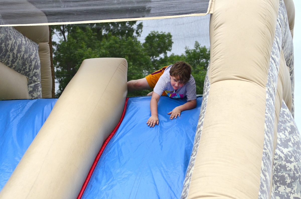 Jack Kramer (from Cedar Rapids) goes over the top of the Iowa Army National Guard&#8217;s inflatable obstacle course Saturday, May 13 during the Solon American Legion&#8217;s Salute to the Troops event.