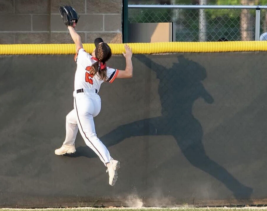 Kayla Meseck (2) climbs the wall in an effort to grab the ball in varsity action last week.