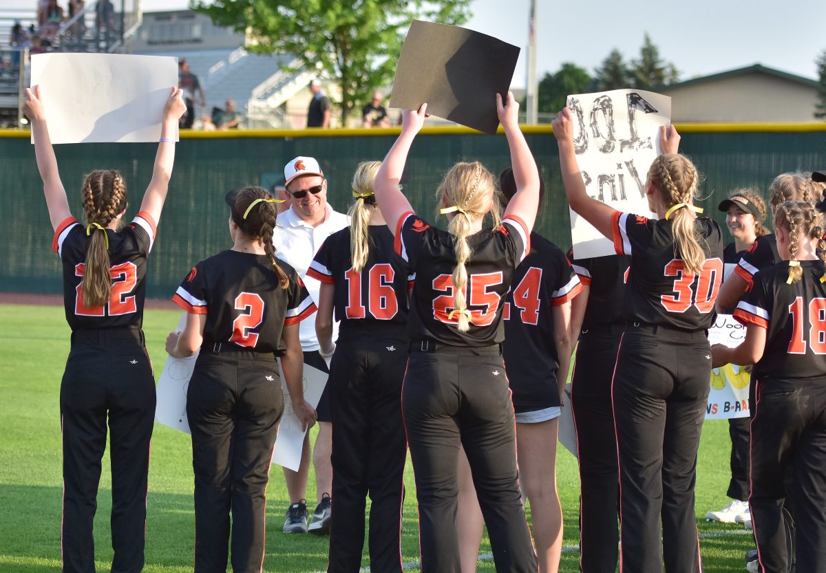 The Lady Spartans surprise Coach Brad Holub with signs celebrating his 100th win Wednesday, May 31 after an 8-2 win over Vinton-Shellsburg. The ladies made it 101 with a 10-5 nightcap win to sweep the varsity doubleheader.