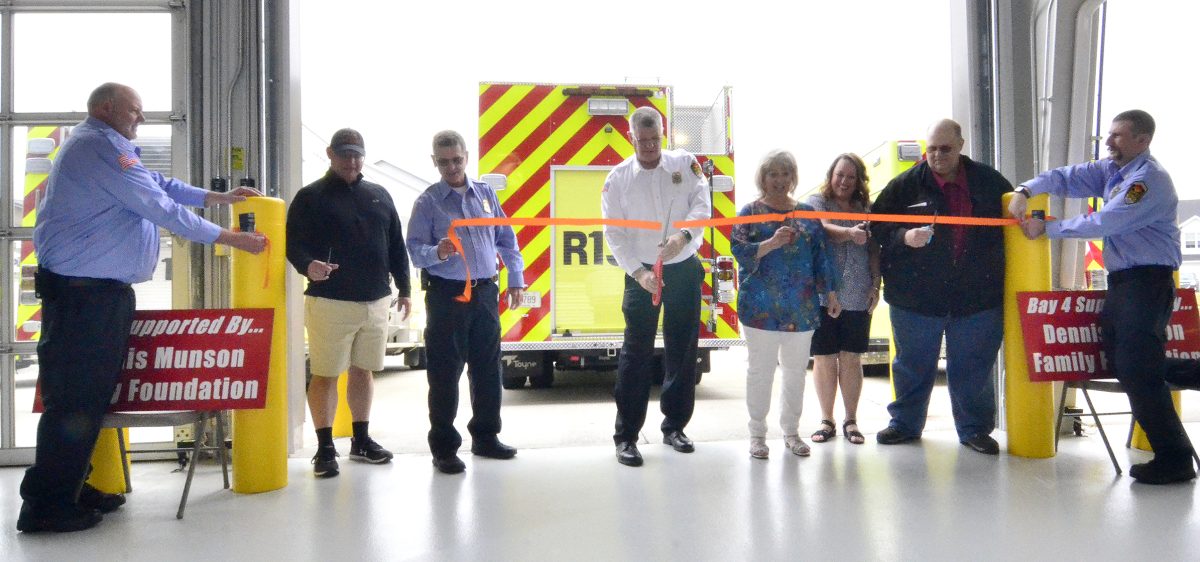 Fire Chief Bob Siddell (center) leads a ribbon cutting Sunday, June 11 during the Solon Tri-Township Fire Department&#8217;s open house and dedication ceremony at the new fire station.