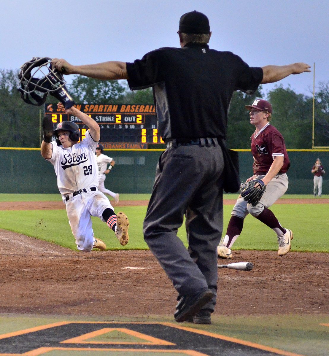 Brett White (28) scores as Nolan Seagren (8) heads to third on a Jackson Link RBI single with an overthrown ball in the fourth inning of game two against Mount Vernon Tuesday, May 23 at home. White had a pair of 2-RBI homers in game one as Solon swept the Mustangs.