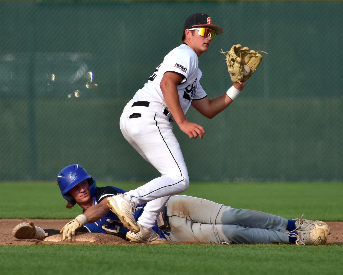 Garret Stebral (22) seeks the umpire&#8217;s confirmation after tagging a Clipper at second base Thursday, June 29 at home in a varsity doubleheader against WaMaC West rival Clear Creek Amana.