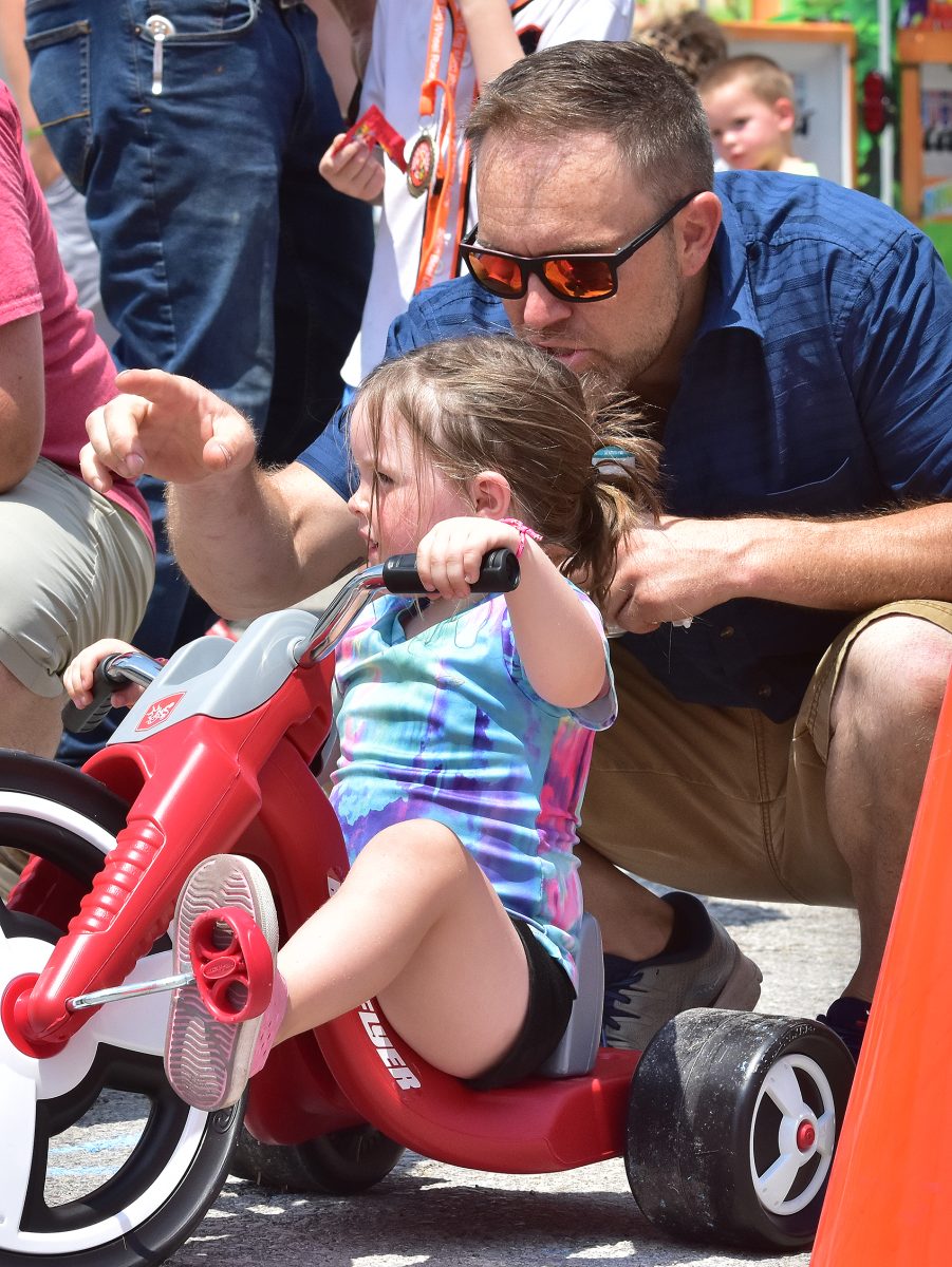 Bill gives his daughter Sloane some last-minute pointers before her heat of the Solon Beef Days Big Wheel Races Saturday, July 22.