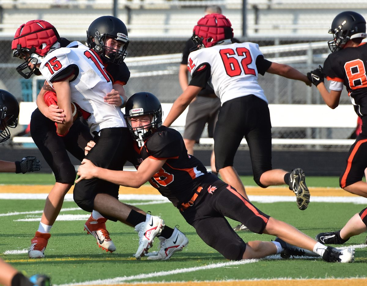 Simon Einwalter (48, at right) and an unidentified Spartan stop a Monticello Panther in his tracks Friday, August 18 during a freshman scrimmage game in Spartan Stadium.