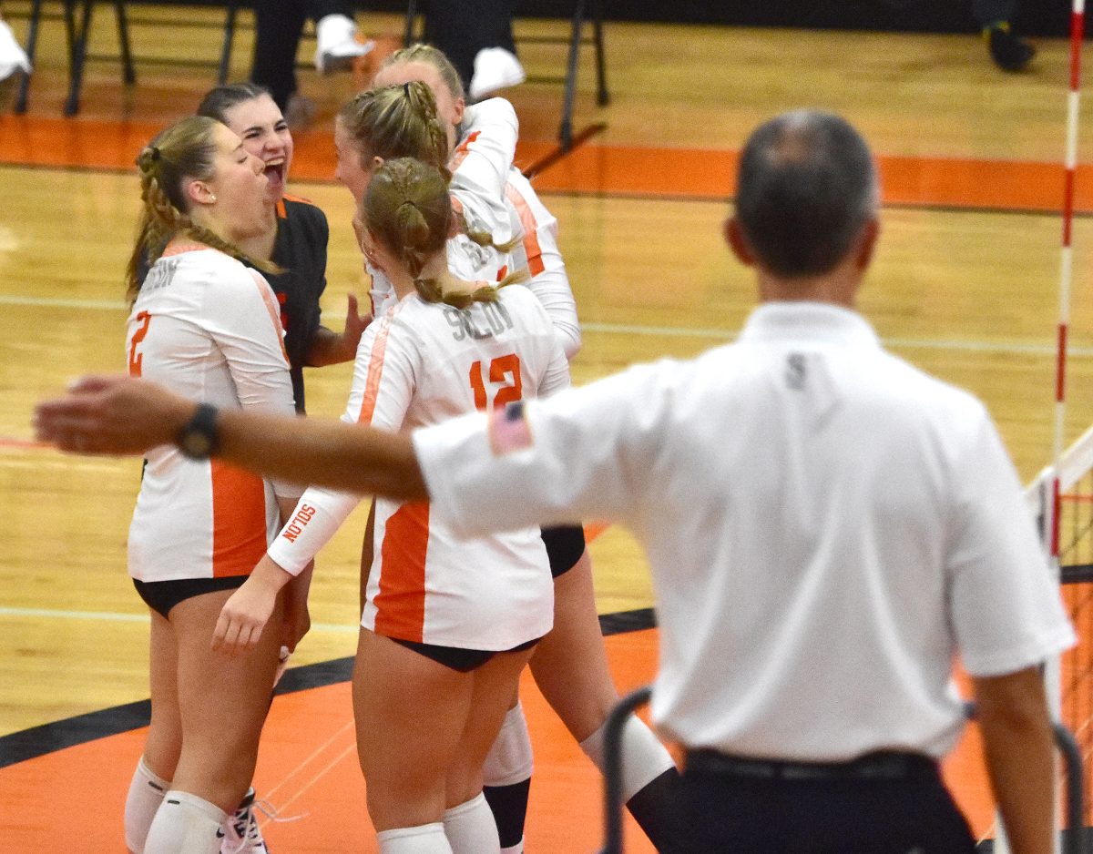 The varsity Lady Spartans celebrate a point against rival Mount Vernon Tuesday, Sept. 5. The Mustangs swept Solon 3-0.