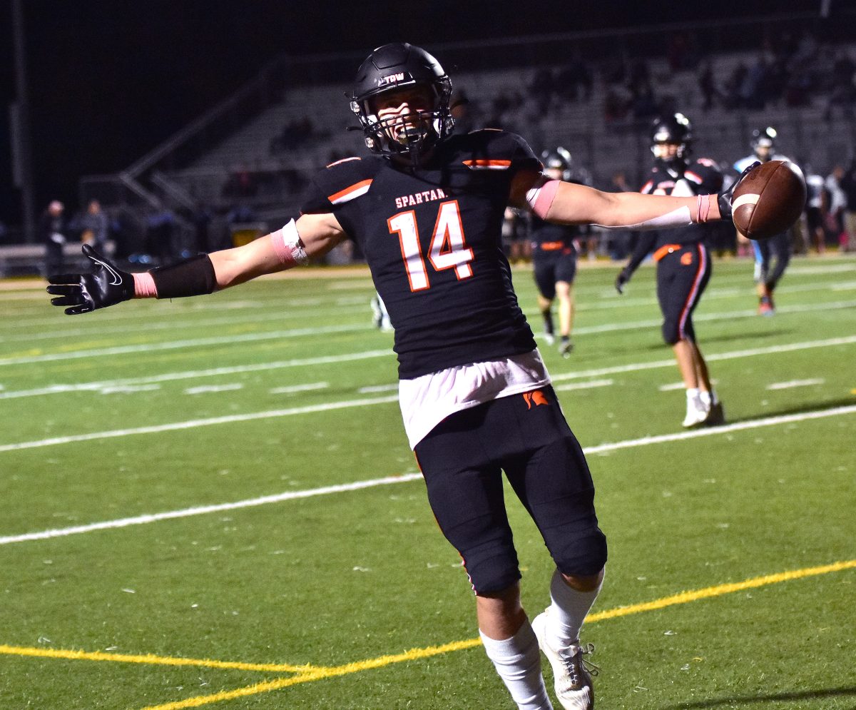 Cole Farnsworth (14) celebrates a 22-yard touchdown pass Friday, October 20 at home against South Tama on Senior Night.