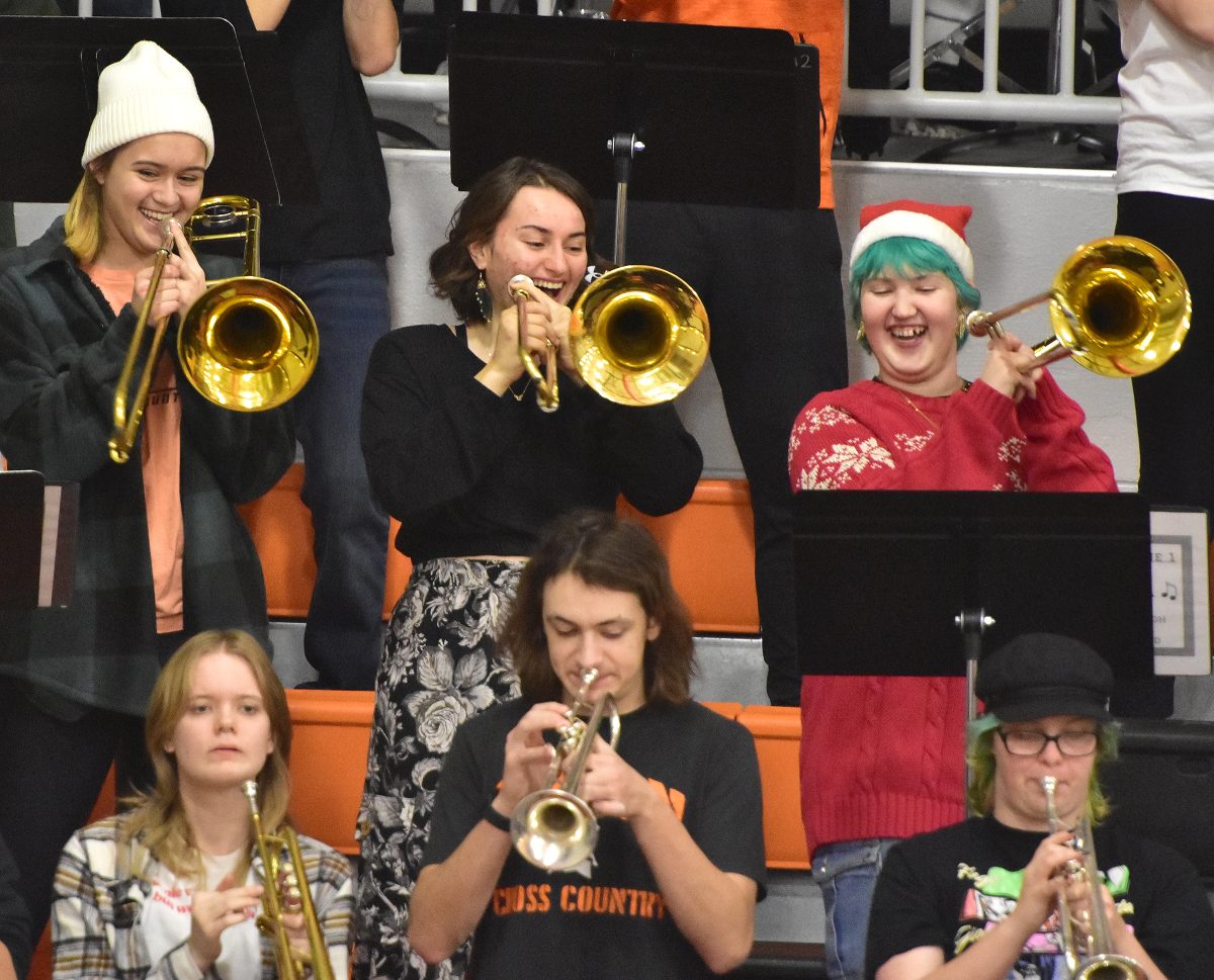 Liona Rocca (top middle) shares a laugh as the Spartan Pep Band performs &#8220;Sleigh Ride&#8221; during a varsity girl-boy basketball doubleheader last Friday. Rocca joined other alumni, parents, and teachers sitting in with the band.